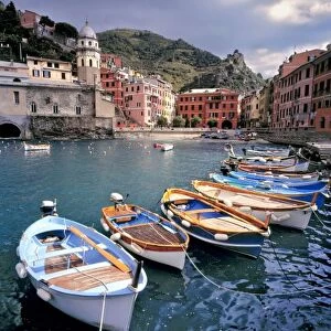Europe, Italy, Vernazza. Brightly painted boats line the dock at Vernazza Harbor