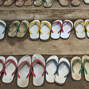 Myanmar, Yangon. Shoes lined up outside a monastery in Yangon