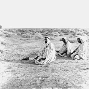 ARABS PRAYING, c1920. Arabs at prayer in the Tunisian desert: photograph, c1920