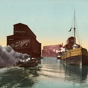 CHICAGO RIVER, c1900. Boats and elevators along the Chicago River in Chicago, Illinois