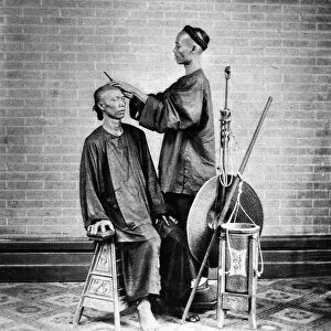 CHINA: BARBER, c1900. A street barber in China, c1900