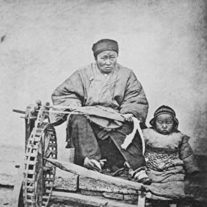 CHINA: COTTON SPINNING 1870s. A woman working a cotton spinning machine, China, 1870s