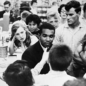 Dion Diamond, a civil rights activist and student at Howard University in Washington, D. C. is surrounded by white youths during a sit-in demonstration at a drug store in Arlington, Virginia, 9 June 1960