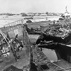 Invasion crafts piled up on wrecked whale causeways at Mulberry Harbor, Normandy, after the storm that followed D-Day, 6 June 1944