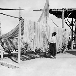 LEBANON: FISHERMAN, c1925. A fisherman drying his nets in Sidon, Lebanon. Photograph