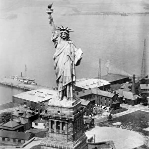 STATUE OF LIBERTY. The Statue of Liberty on Liberty Island in the New York Harbor seen from an army plane. Photograph, late 19th or early 20th century