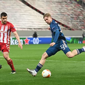Arsenal's Emile Smith Rowe Clashes with Olympiacos Sokratis in Empty Europa League Arena