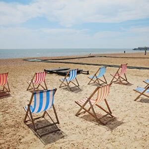 Great Britain, England, East Sussex, Hastings, rows of wooden deckchairs on sandy beach