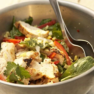 Grilled Thai chicken and Chinese cabbage salad with peanut-lime dressing, in silver coloured bowl, salad servers