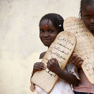 Islamic schoolgirls holding prayer tablets