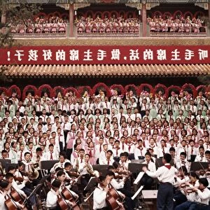 A mass chorus formed by peking (beijing) children singing the revolutionary song we are successors to communism at chingshan park in celebration of international labor day on may 1st (may day), the banner reads listen to chairman maos words, be chairman maos good children, 1965