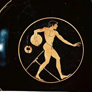 Red-figure pottery attic kylix depicting disc-thrower