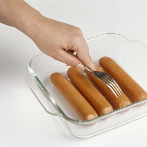 Using fork to prick microwave hot dog sausages