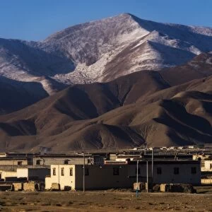 Tibetan style houses and the mountain range, Tibet, China