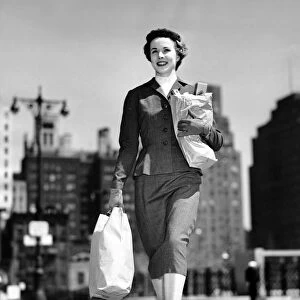 Woman walking, carrying bag