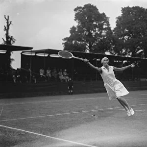 Surrey tennis championship at Surbiton. Miss Tapscott ( South Africa ) makes a leap for the ball