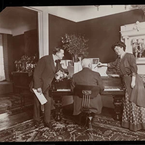 Clara De Regand pointing to a score while a man plays the piano
