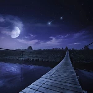 A bridge across the river at night against starry sky, Russia