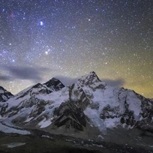 The bright stars of Auriga and Taurus rise above Mt. Everest and the central Himalayas