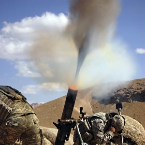 U. S. Army soldiers firing a 120mm mortar during combat operations in Afghanistan