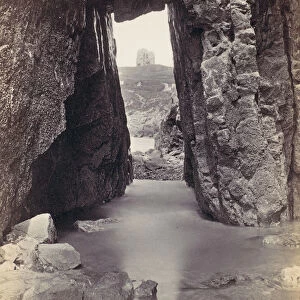 [View Through Rocks Of Tower On Hill], 1870s. Creator: Francis Bedford