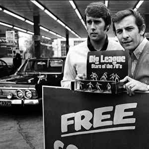 Geoff Hurst and Alan Mullery pose with football figurines in a garage in Acton in 1971