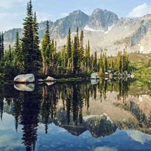 Eaglecap Wilderness, Oregon, United States Of America; Reflections Of The Trees And Mountains In Blue Lake