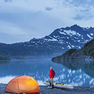 Man Camping With A Tent And Kayak At Shoup Bay State Marine Park, Prince William Sound, Valdez, Southcentral Alaska