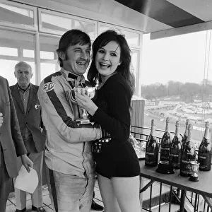 Actress and former model Madeline Smith presents a trophy