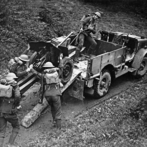 Anti tank gun being unloaded from a transport truck at the double to ready for action at