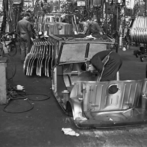 Austin Mini body panels are assembled prior to welding and being placed on the production