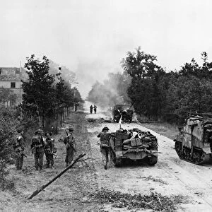 British armoured vehicles on fire in the early stages of the Allied air