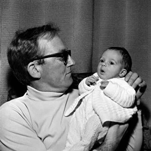 Families: Father holding his newly born baby boy at their home. December 1969 Z12116