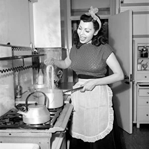 A Housewife cooking spaghetti in the kitchen, 1957