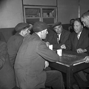 Hugh Gaitskell, MP, 1958 talks with Liverpool dockers over a mug of tea in Gladstone Dock