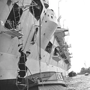Leading Seaman Philip Benjamin climbs down a rope ladder from HMS Eagle to an awaiting
