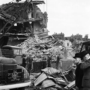 Members of the LCC salvage squad and members of the ARP search the rubble of a V1