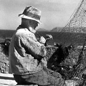 Net making, a fisherman in Cornwall, circa January 1944