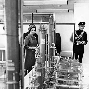 Queen Elizabeth II looks at a model of the new refinery at Milford Haven