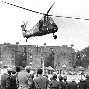 A Royal Navy Westland Wessex helicopter lands on the sportsfield of the Royal Grammar