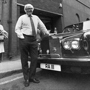 Sir Richard Attenborough leans on the bonnet of a Rolls Royce car