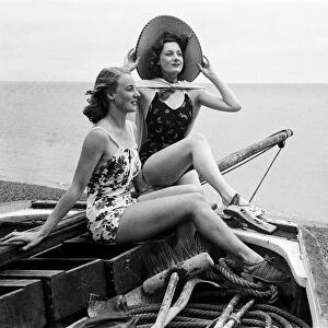 Women in their bathing costumes in a fishing boat along the coast, Hastings, circa 1945