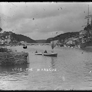 Looe Harbour with masted ship at Granite Quay