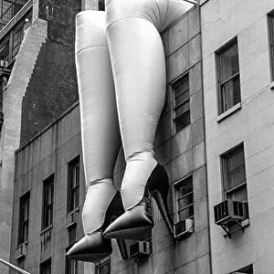 A huge pair of inflated female legs on a building in midtown Manhattan advertise an exhibition at the nearby Museum of Modern Art