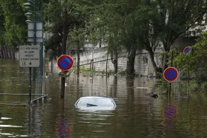 France Prints: An abandoned car is submerged in deep water on the flooded river-side of the River Seine