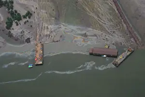 Oil Prints: An aerial view shows boats and barges used to help plug an oil leak in the waterways of