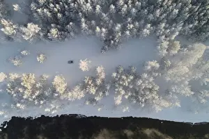 An aerial view shows a car driving along a bank of the Yenisei River outside Krasnoyarsk
