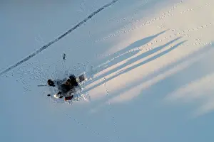Prints of An aerial view shows men making a cross-shaped ice hole on the frozen Yenisei River on the eve of Orthodox Epiphany Russia Prints: An aerial view shows men making a cross-shaped ice hole on the frozen Yenisei River