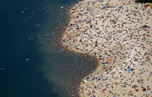An aerial view shows people at a beach on the shores of the Silbersee lake on a hot