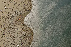 Weather Prints: An aerial view shows people at a beach on the shores of the Silbersee lake on a hot